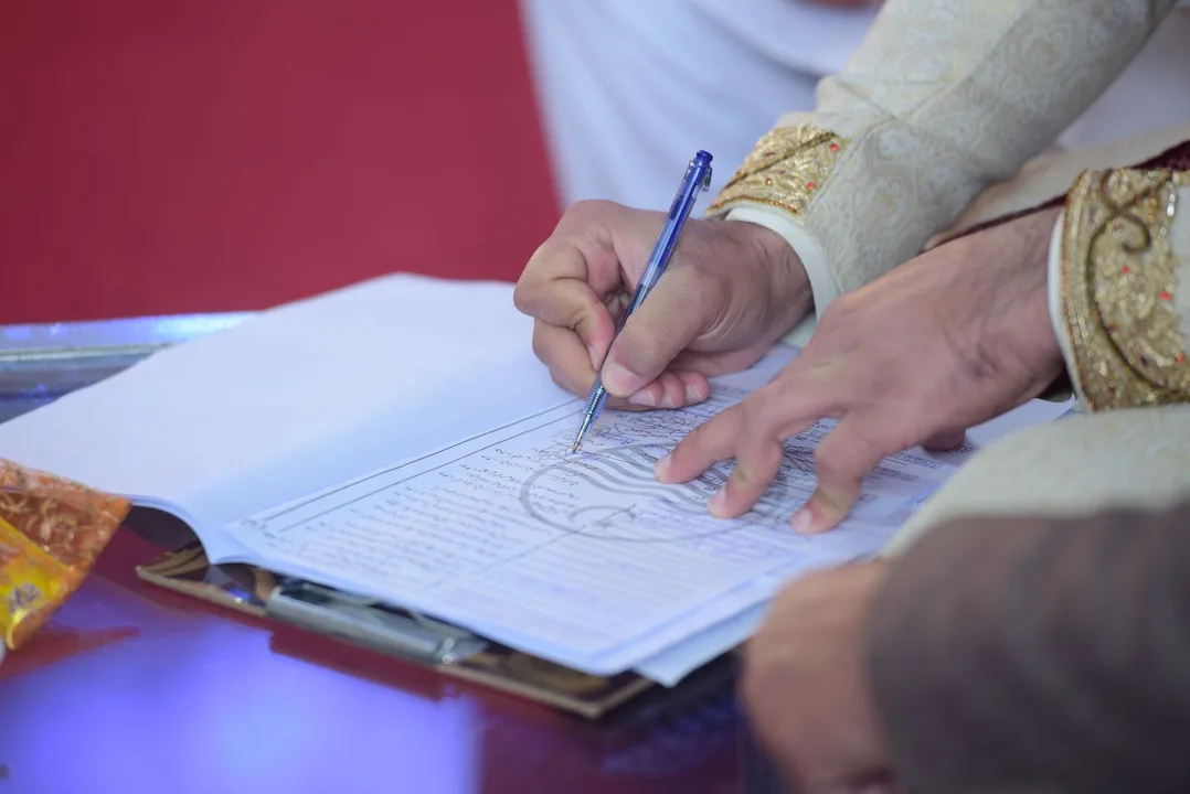 A modest wedding setting, with Nikah documents and floral details